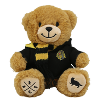 A plush toy depicting a teddy bear with a Hogwarts House robe and a yellow-and-black scarf, featuring screen-printed details on its paw pads.